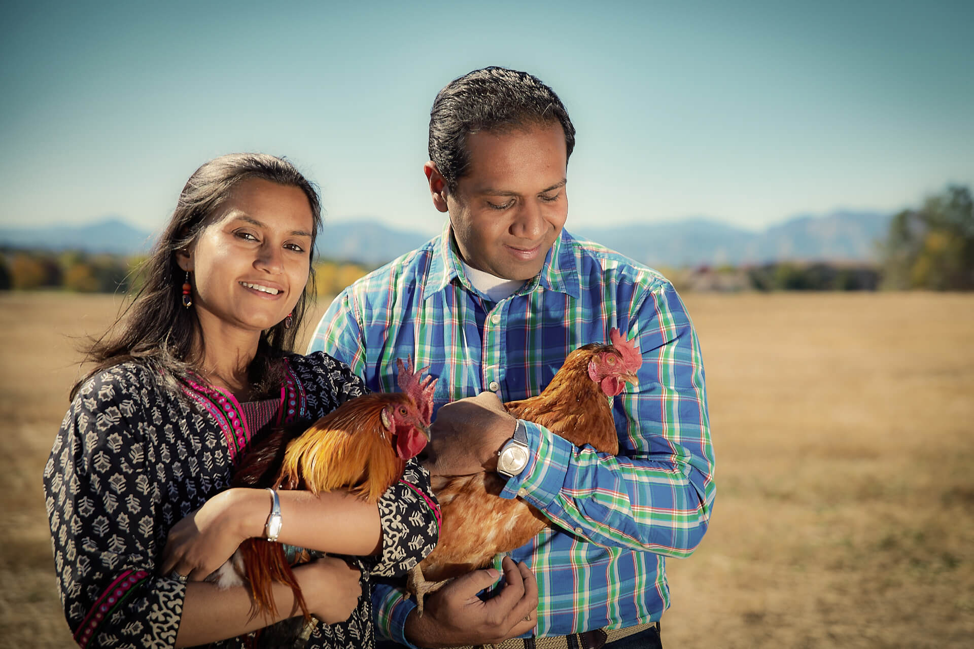 Founders, Shaleen and Shilpi Shahs holding rescued chickens